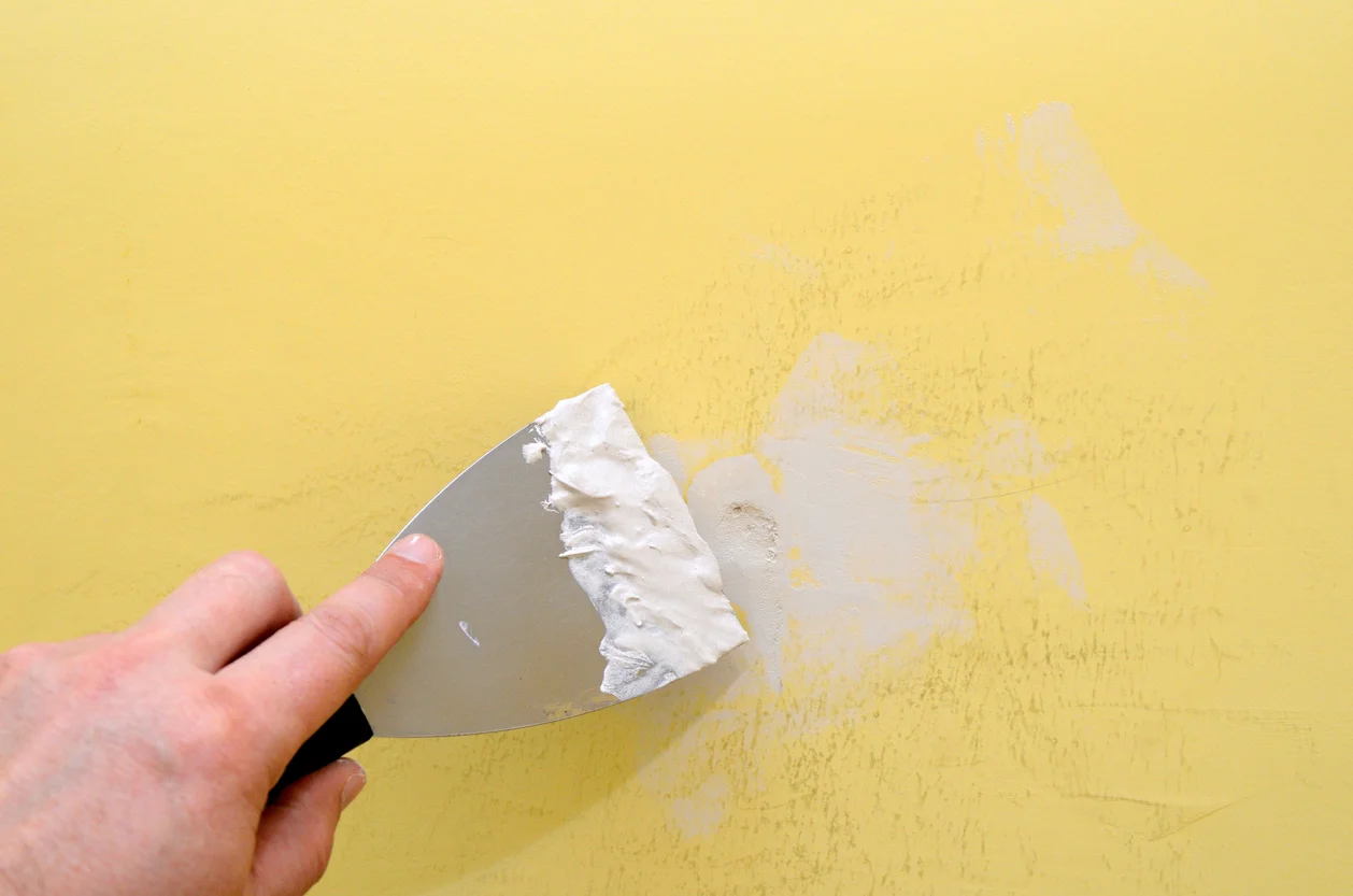 Applying The Spackle To Fill In Any Holes Or Imperfections